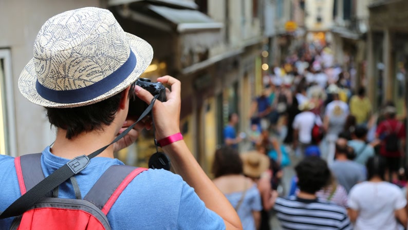 Tourist taking a photo of a busy street